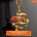 A detailed Miami Hurricanes Sebastian the Ibis pendant necklace, heavily embellished with rhinestones in orange, yellow, green, and silver, hanging from a gold-tone chain. An orange banner at the bottom features the text 'MIAMI HURRICANES SEBASTIAN THE IBIS TURNOVER CHAIN' and the EliteAuto brand logo.