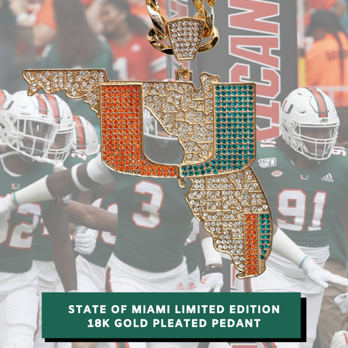A Florida-shaped 18K gold pleated pendant covered in rhinestones, featuring orange and teal sections, shown against a blurred Miami football team background. Text at the bottom reads 'STATE OF MIAMI LIMITED EDITION 18K GOLD PLEATED PENDANT'.