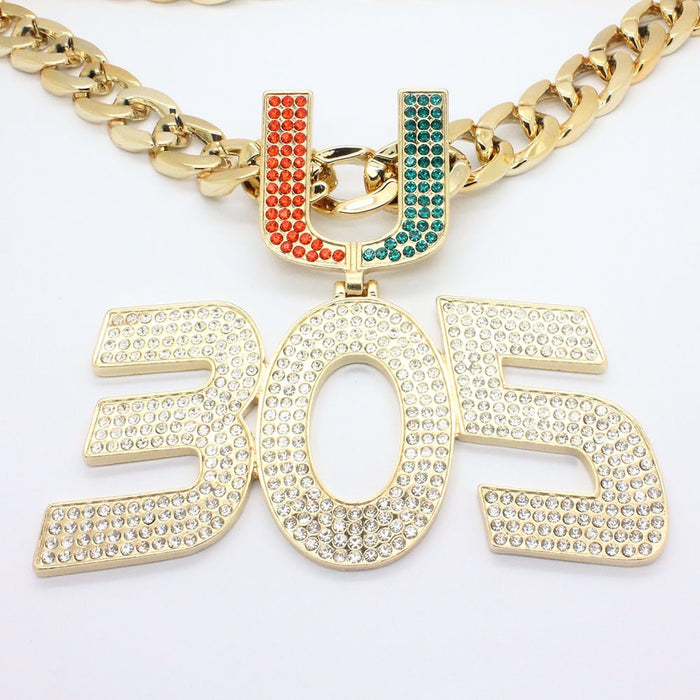 Gold chain necklace with a large '305' pendant and a 'U' charm embellished with red and green rhinestones, set against a plain white background.