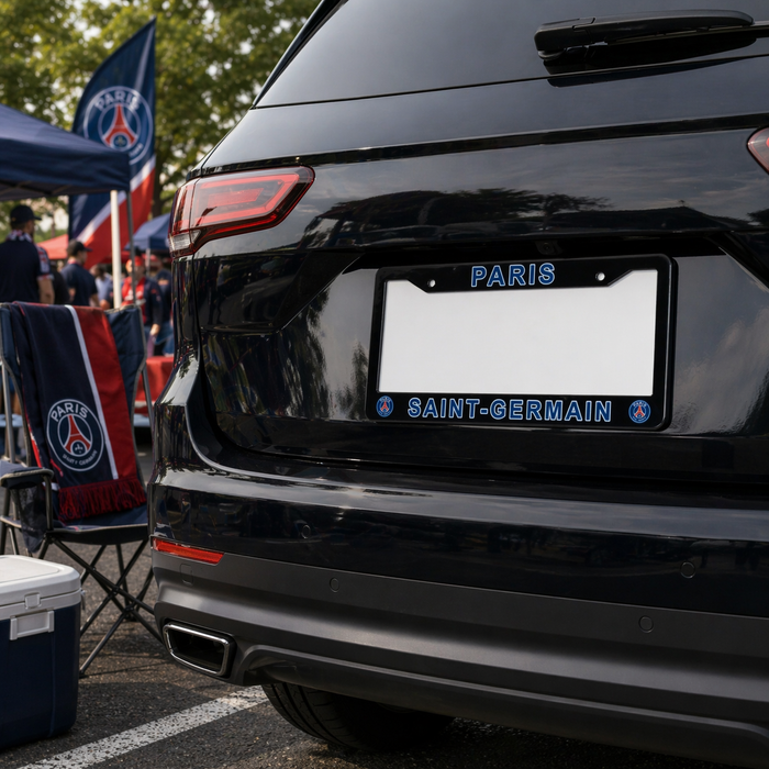 Black car with a Paris Saint-Germain license plate frame at an outdoor event.