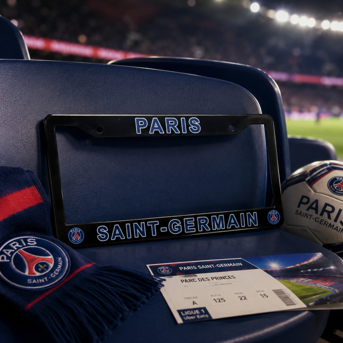 A Paris Saint-Germain license plate frame mounted on a blue stadium seat, with a matching scarf, ticket, and soccer ball nearby in a stadium setting.
