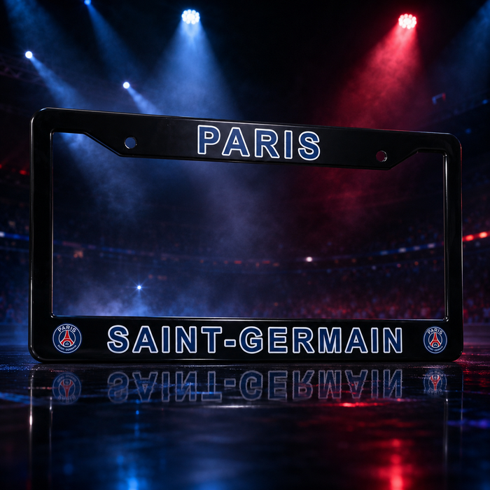 A black license plate frame featuring 'PARIS' at the top and 'SAINT-GERMAIN' at the bottom, with PSG club crests in the corners, set against a dramatic stadium background with blue and red lights.
