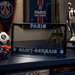 Paris Saint-Germain license plate frame with team logo and text on a dark surface.