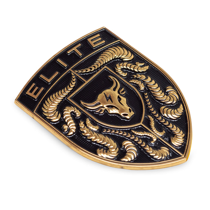A gold and black porsche emblem featuring the word 'ELITE' at the top, a bull head in the center, and crumrine designs around the border, shown on a plain white background.
