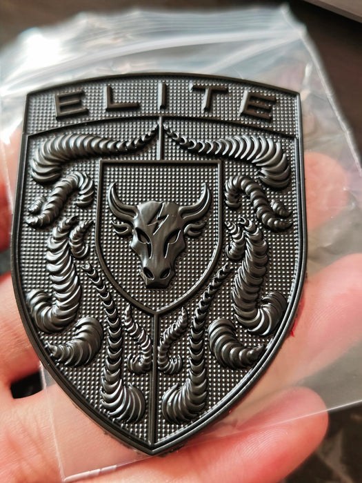 Real Life picture of the Elite Black Porsche Hood Emblem being held in hand.