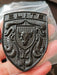 Real Life picture of the Elite Black Porsche Hood Emblem being held in hand.
