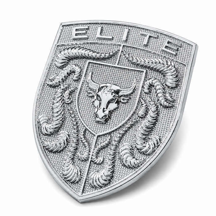 A silver-toned shield-shaped porsche emblem or badge featuring the word 'ELITE' at the top, a bull head in the center, and crumrine details around the border, shown on a plain light gray background.