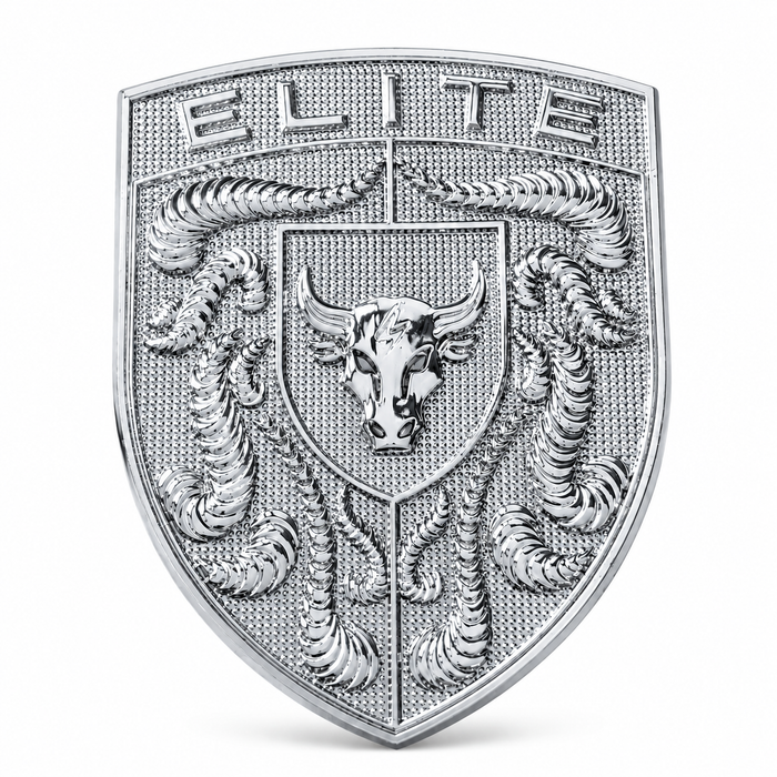 A silver-toned shield-shaped porsche emblem or badge featuring the word 'ELITE' at the top, a bull head in the center, and crumrine details, shown on a plain light gray background.