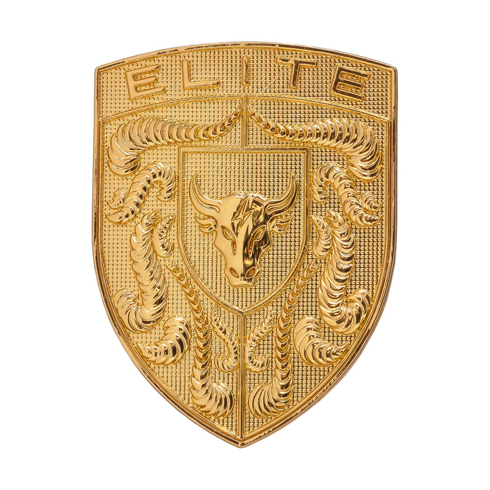 A gold porsche emblem or badge featuring the word 'ELITE' at the top, a central bull head, and detailed sculpted decorative elements on a plain white background.