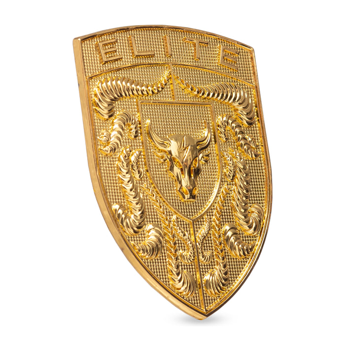 A gold porsche badge or emblem featuring a bull head in the center, crumrine designs, and the word 'ELITE' at the top, shown on a plain white background.
