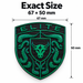 A Porsche Irish Green Brahma Bull Hood Emblem and crumrine designs on a black textured background, with text above reading 'Exact Size 67 x 50 mm' and size arrows marking 67 mm wide and 50 mm tall.