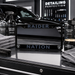 A black license plate frame with 'RAIDER' and 'NATION' in gray lettering, flanked by detailing products including Ceramic Spray, Detail Spray, Graphene Wax, and Premium Cannabwa Wax on a glossy black surface.