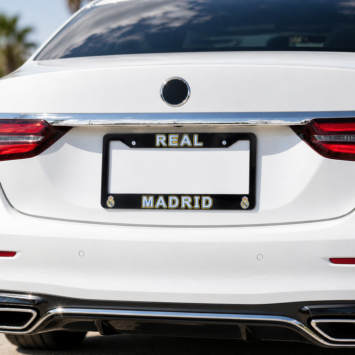 White car with a black license plate frame displaying 'REAL MADRID'