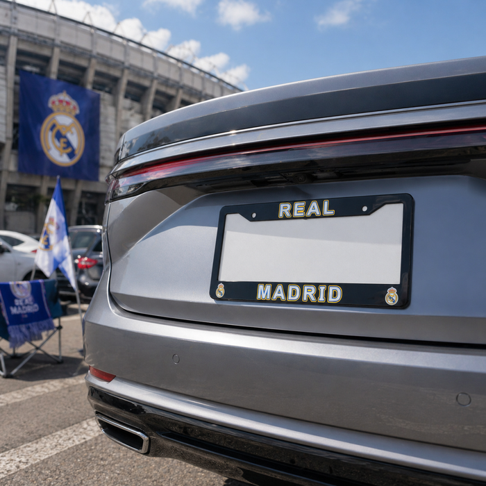 Car with 'Real Madrid' license plate in front of a stadium with flags.